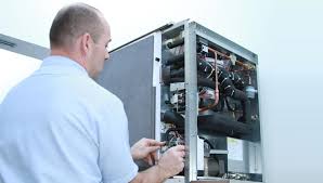 Technician inspects and repairs internal components of an electronic equipment cabinet
