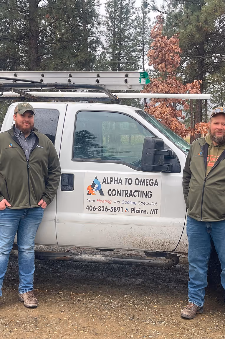 Two men standing in front of a white truck.