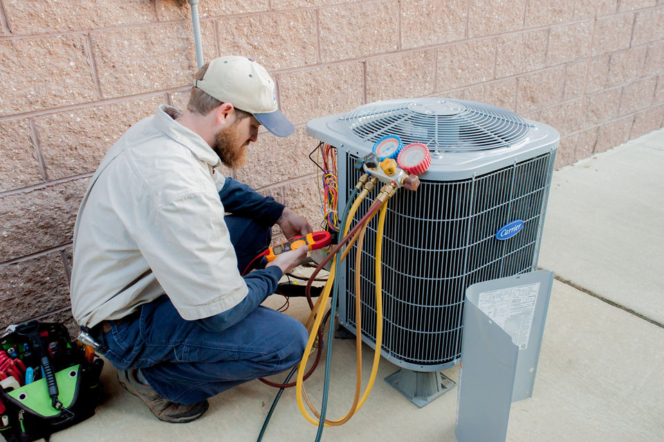 An Expert doing a service of HVAC Unit with tools