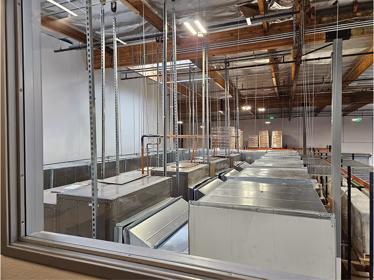Industrial warehouse interior with metal shelving and large refrigeration units