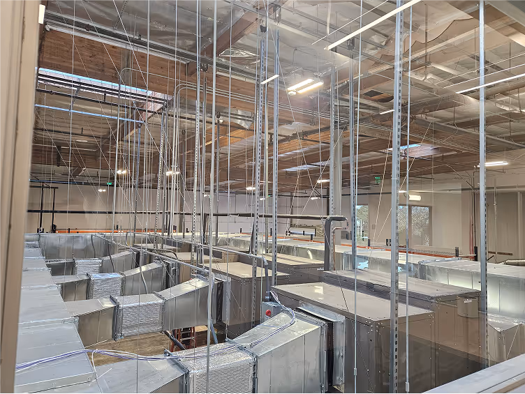 Industrial facility with metal ductwork, shelving, and complex ventilation system
