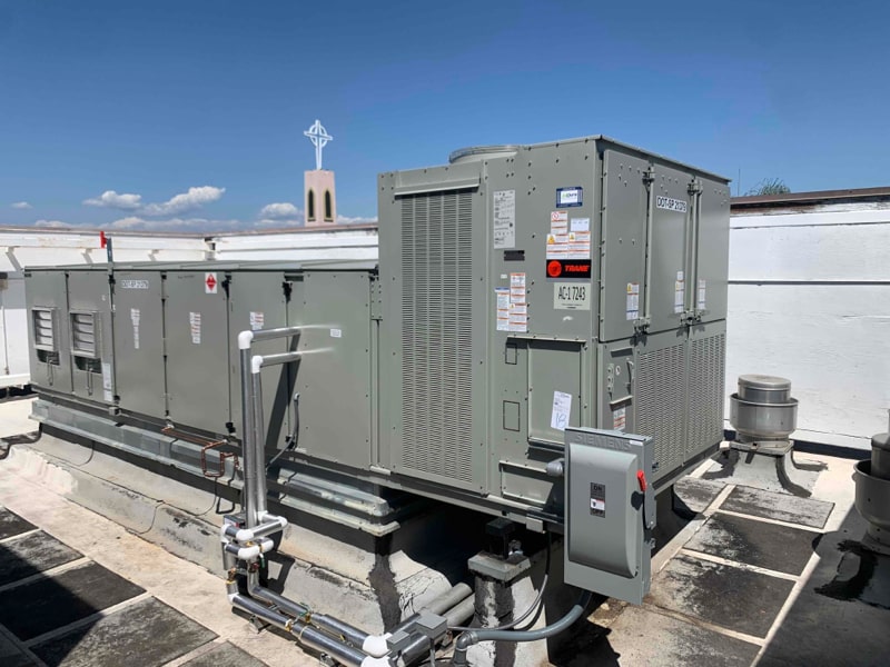 Large commercial HVAC units on a rooftop under blue sky