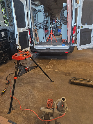 Work van interior with tools and repair stand on workshop floor