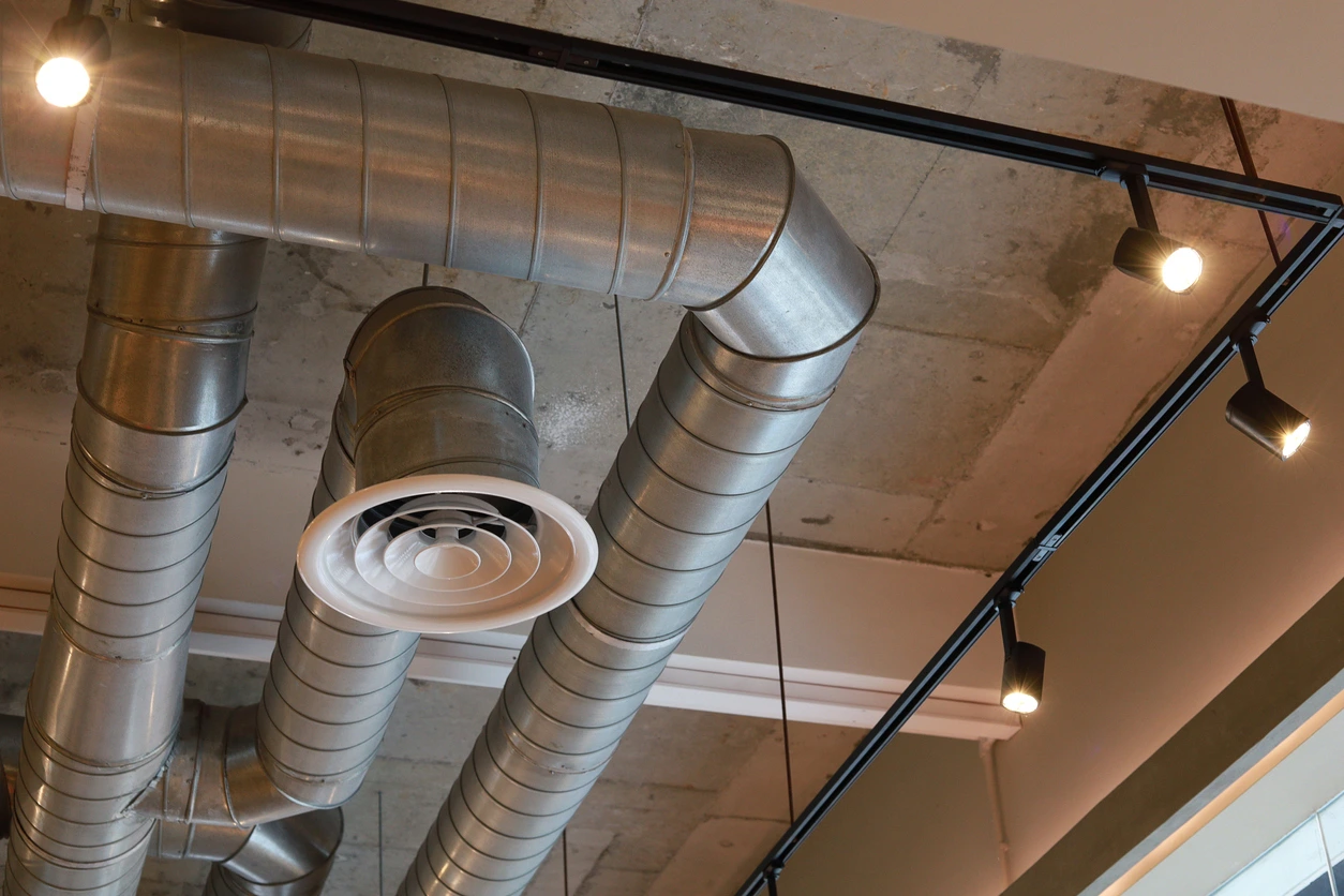 Industrial metal air ducts and ventilation system on concrete ceiling