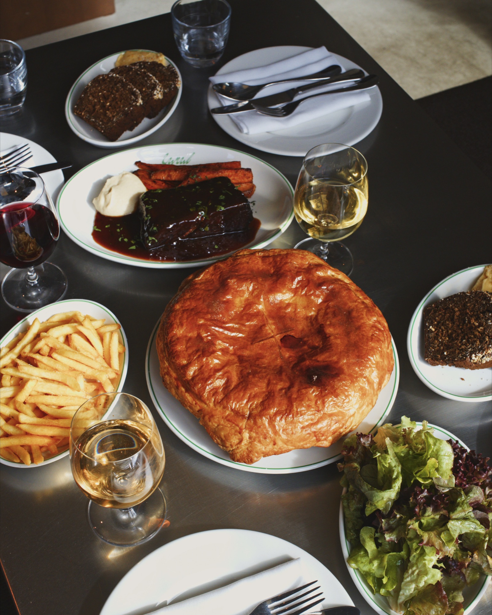 A festive table at Canal with curried monkfish pie, braised short rib, fries and winter leaves