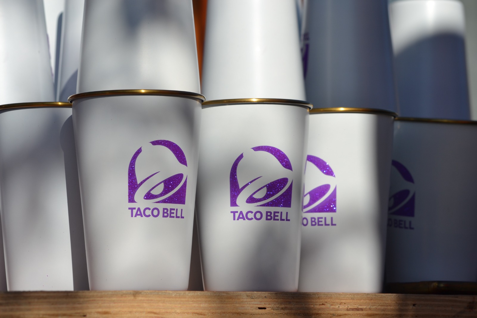 Custom Taco Bell promotional cups lined up in a rack during finishing at Nexform