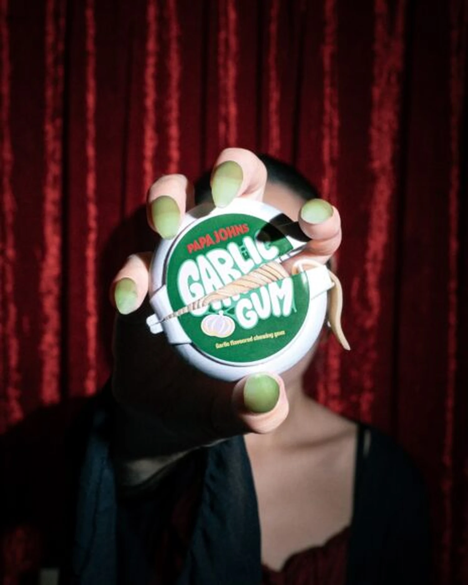 Papa Johns garlic gum housing held in a hand to show its size