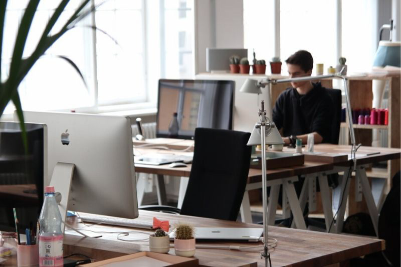 stock photo casual office setting person at desk