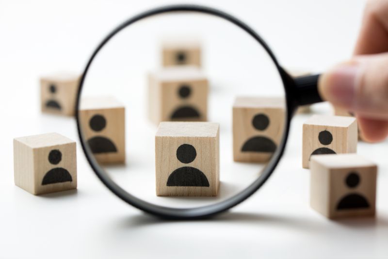 stock photo magnifying glass over blocks with user icons
