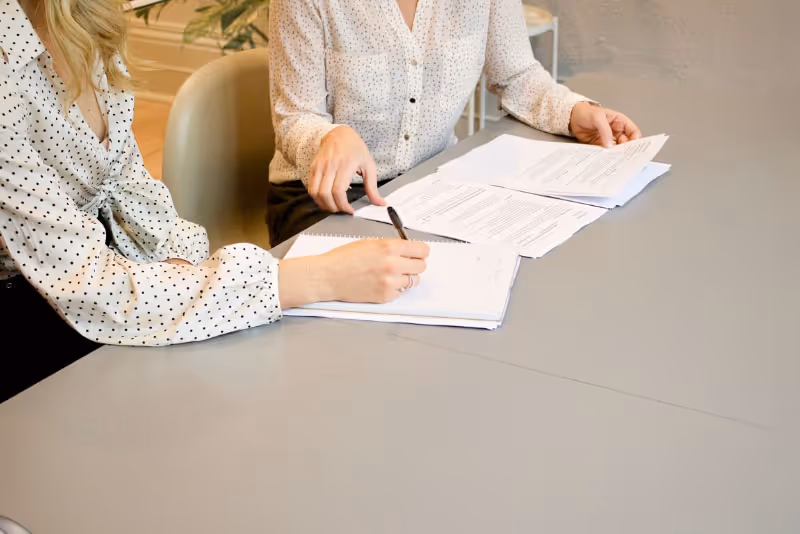 stock photo two people at table with papers discussing