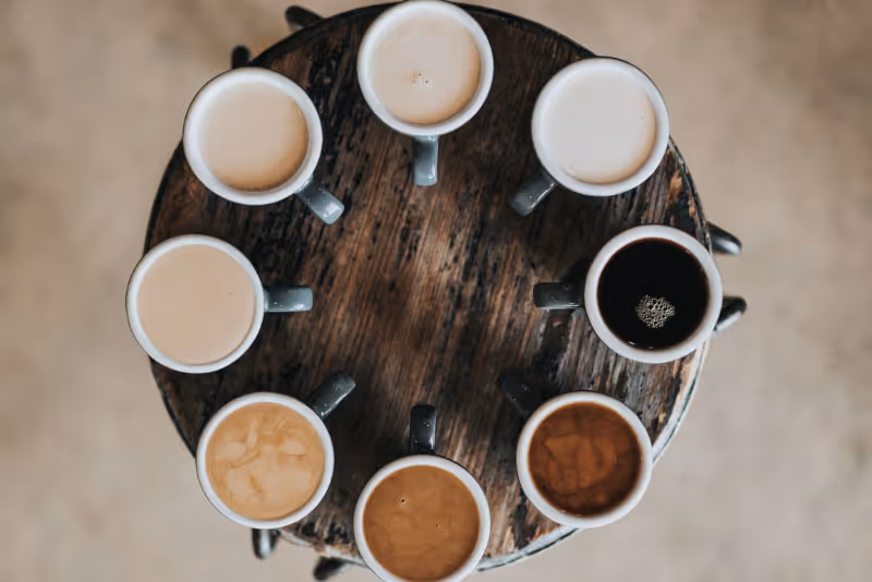 stock photo mugs with different coloured liquid from above
