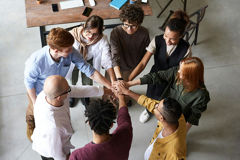 stock photo group of people with hands tether in enter