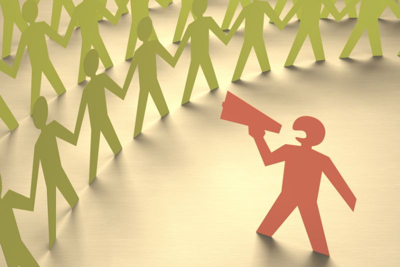 stock photo paper cutouts of people with one using a megaphone