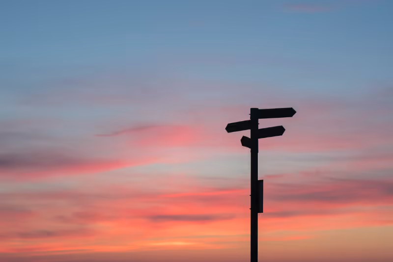stock photo sign post with sunset behind