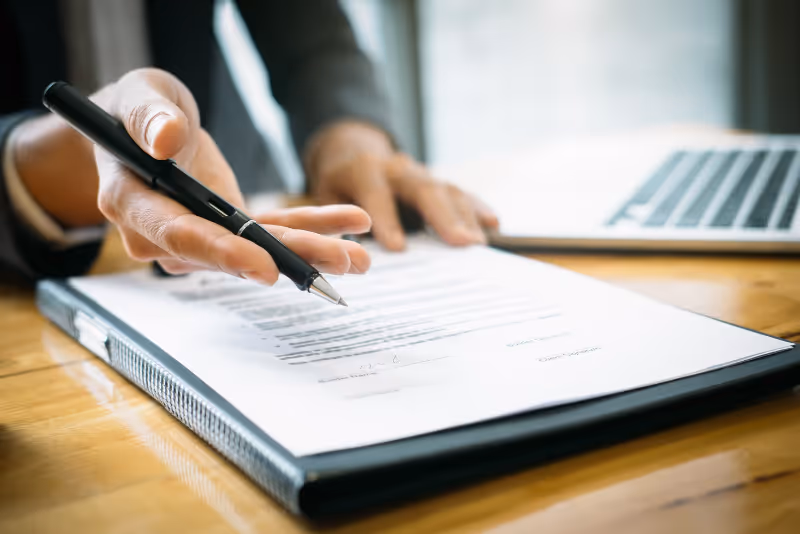 stock photo person writing with papers on desk