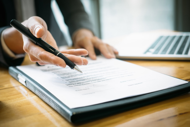 stock photo person writing with papers on desk