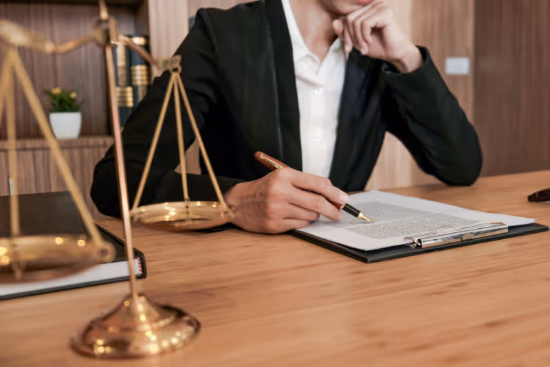 stock photo woman in suit at table with judicial scales