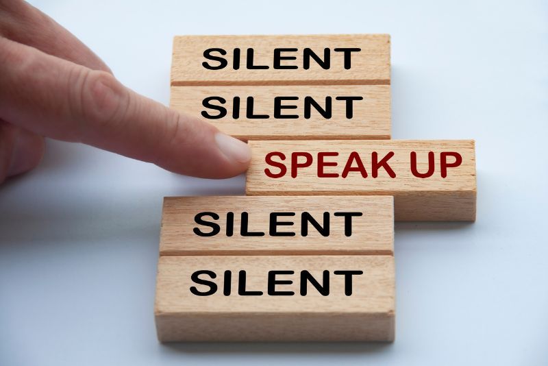 stock photo wood blocks with text silent finger on one block text speak up