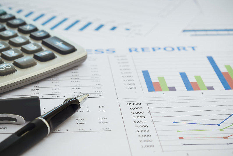 stock photo closeup of calculator and charts and graphs
