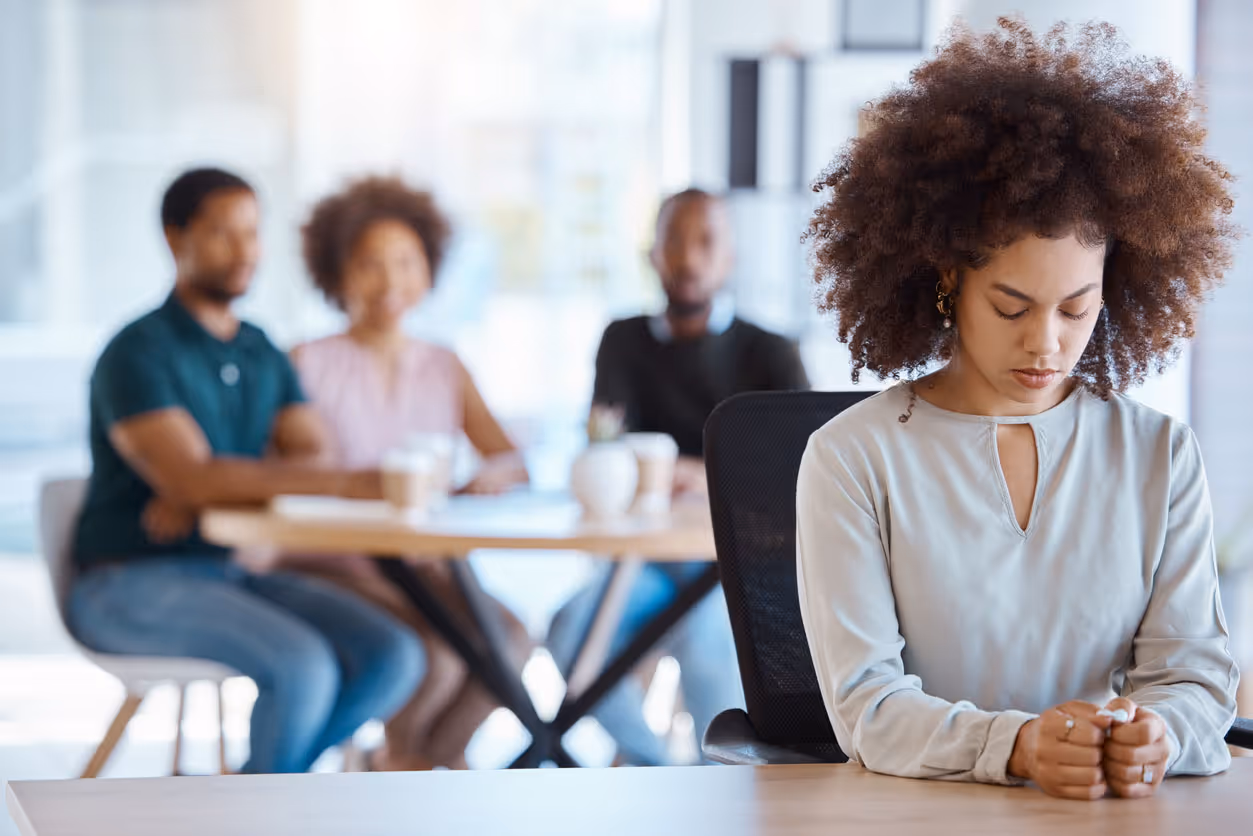 stockphoto woman at table with people at table in background out of focus