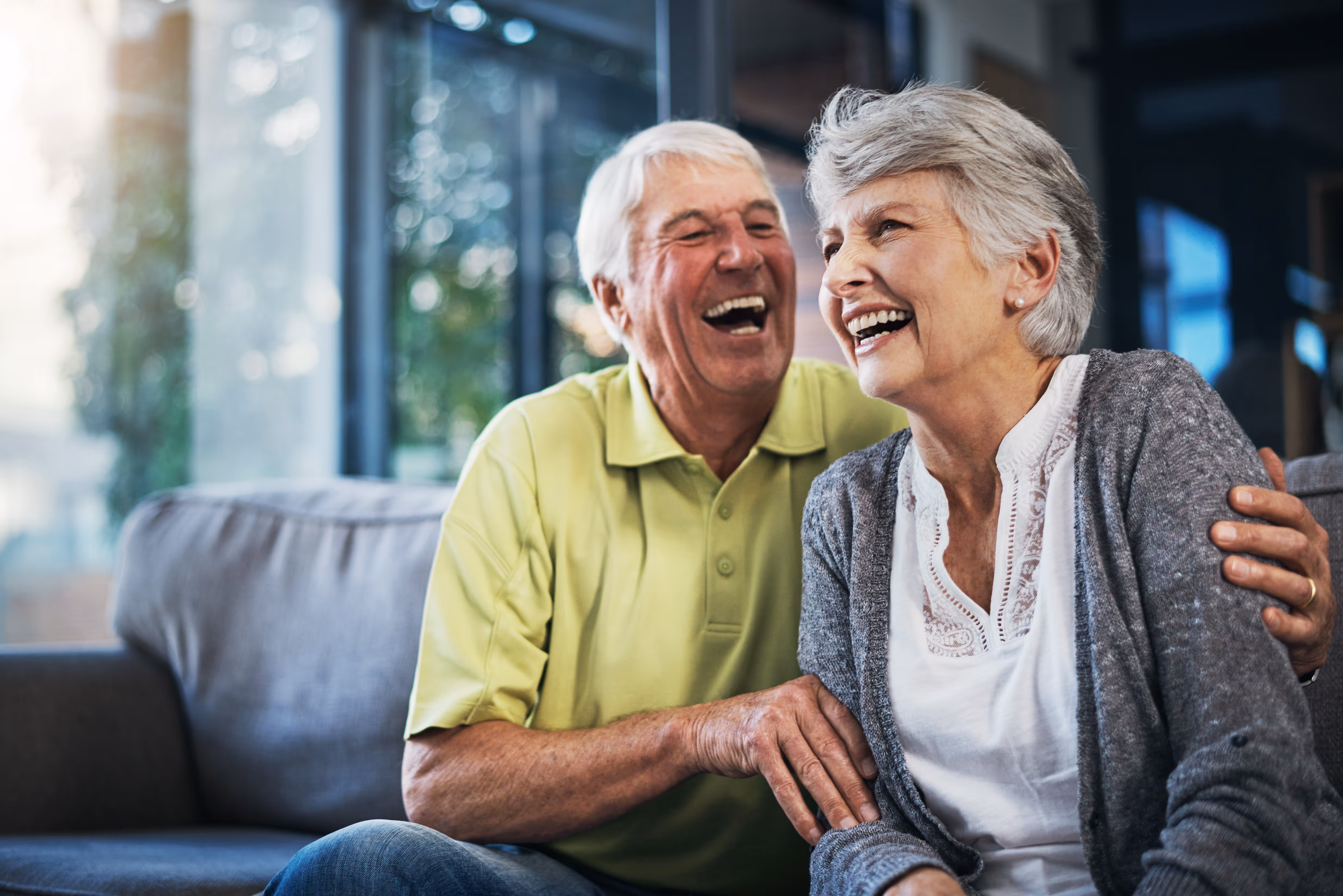 couple laughing on couch