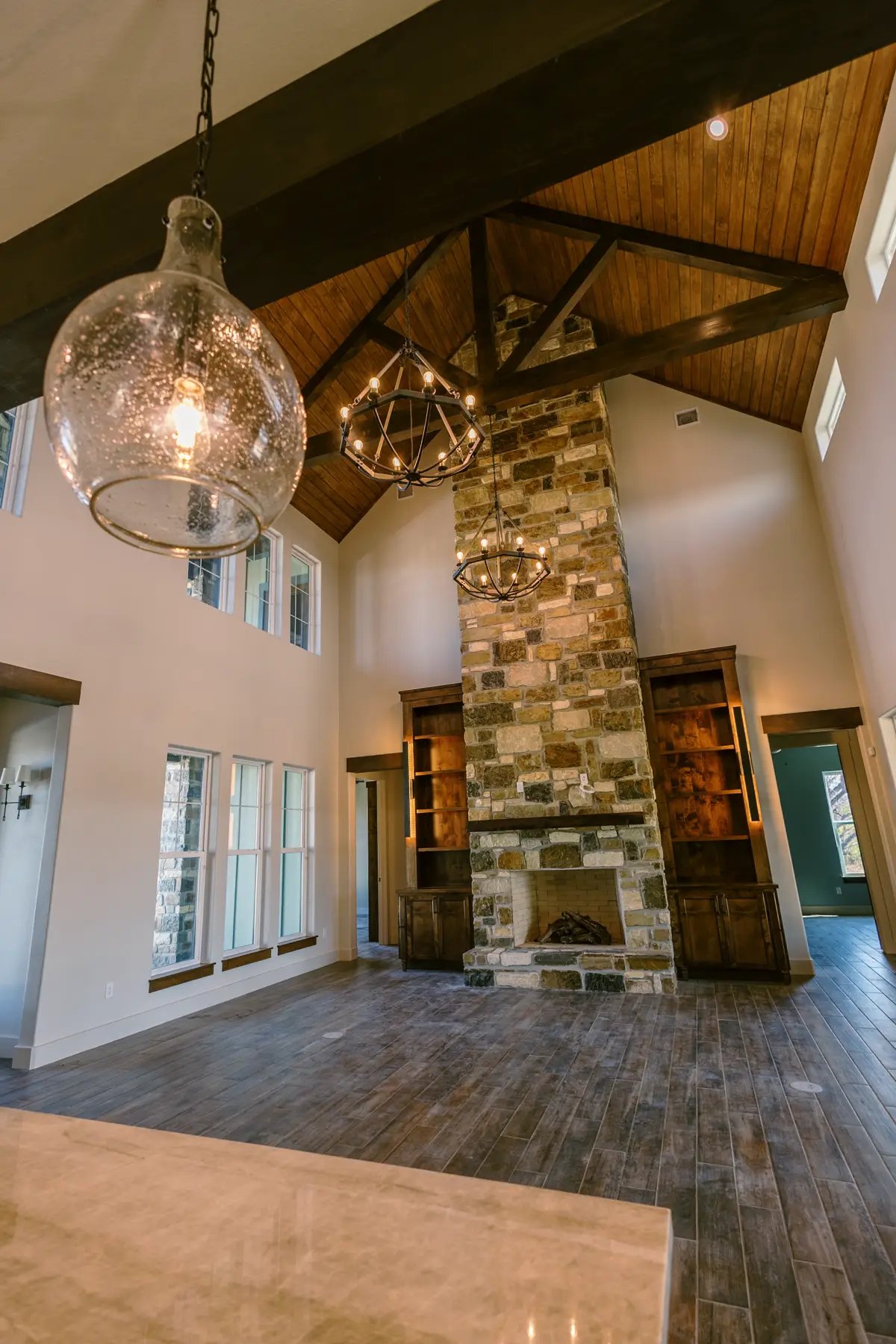 custom built fireplace with stone and cabinets on the sides