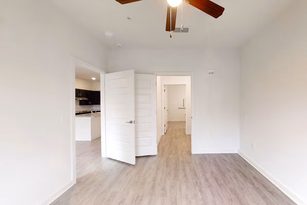 bedroom with view of bathroom and closet