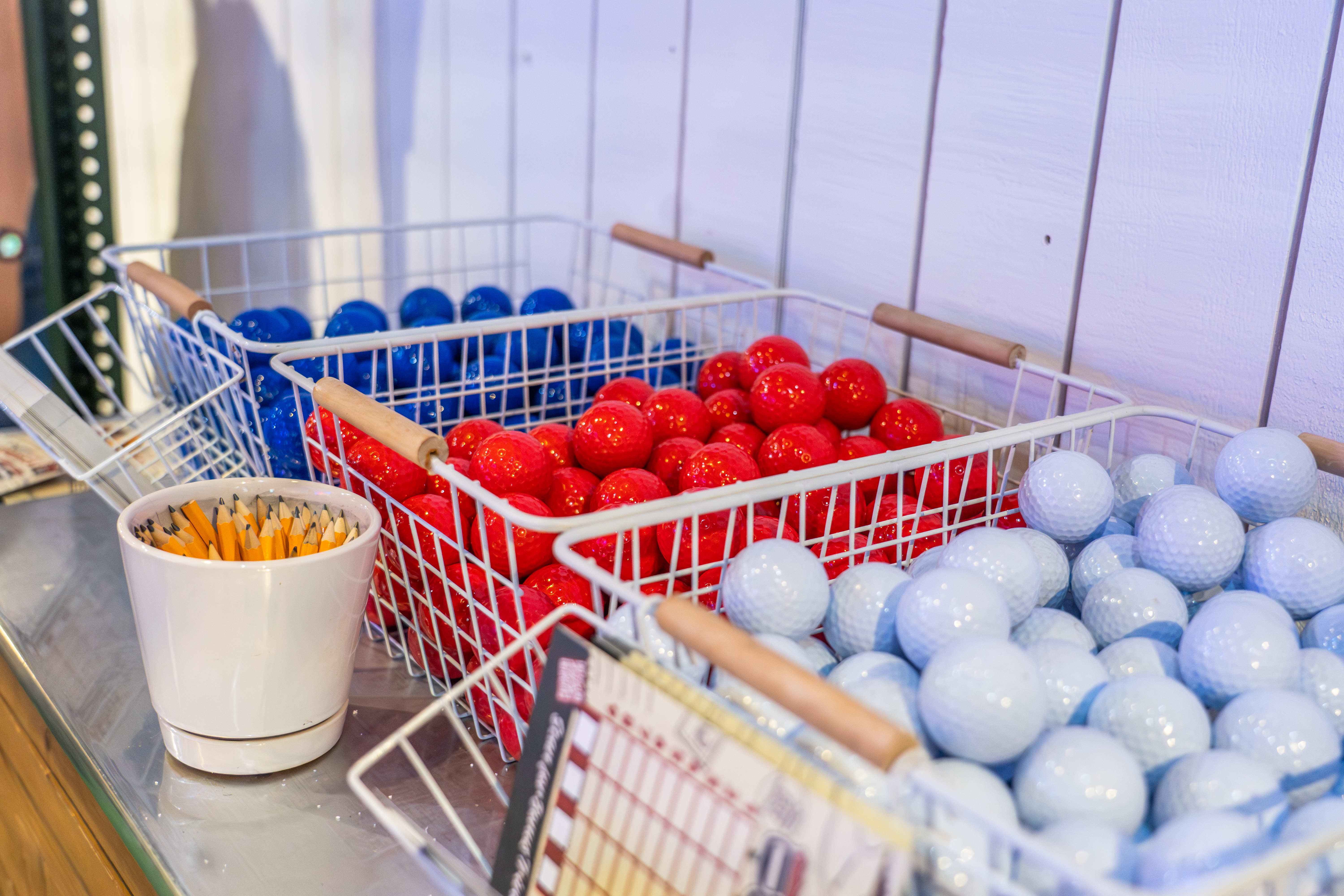 Baskets of colorful mini golf balls