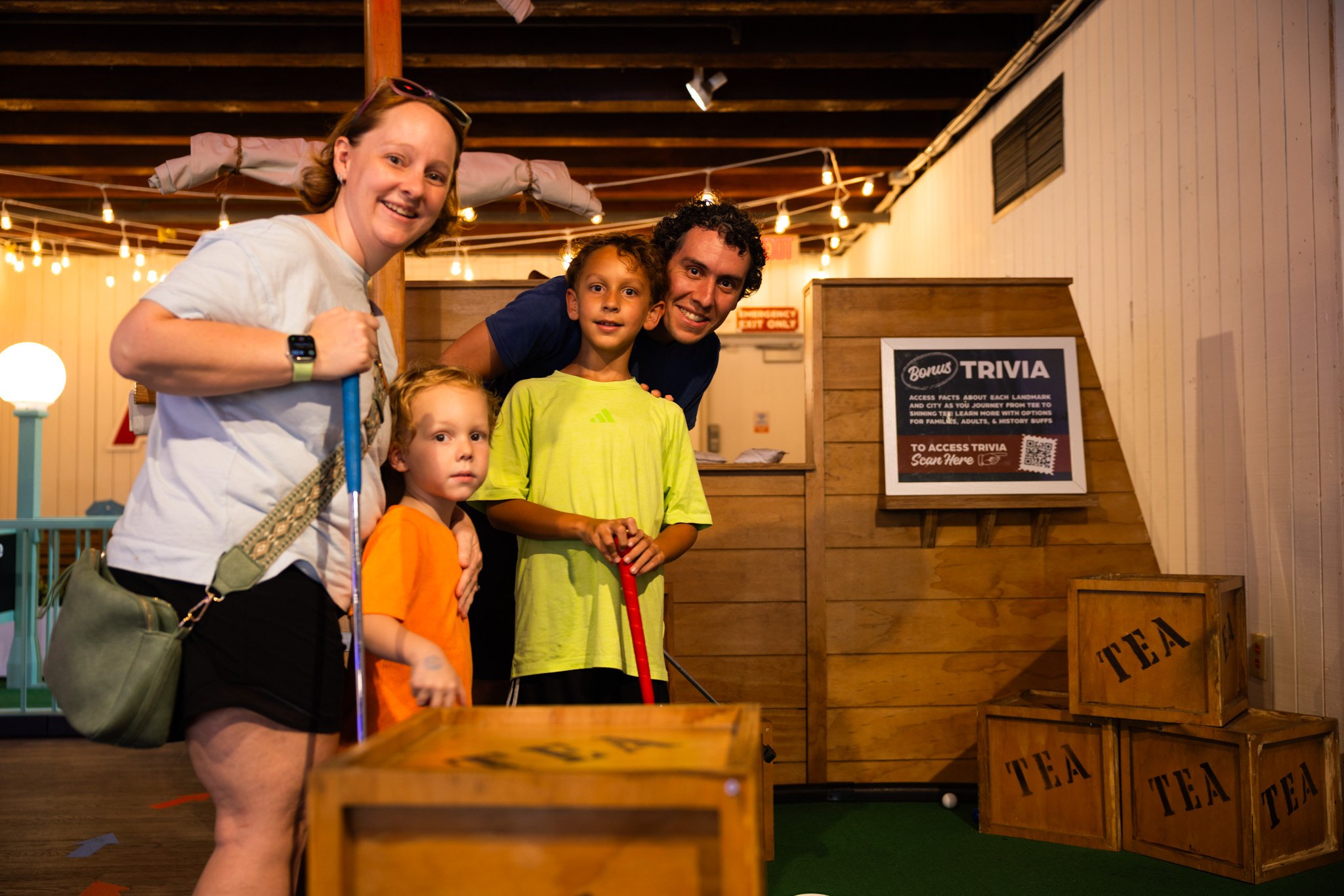 Family playing bonus trivia at Putt Across America