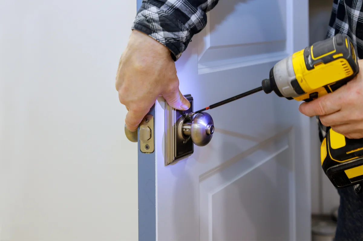 DEX technician installing a new door lock in Dubai