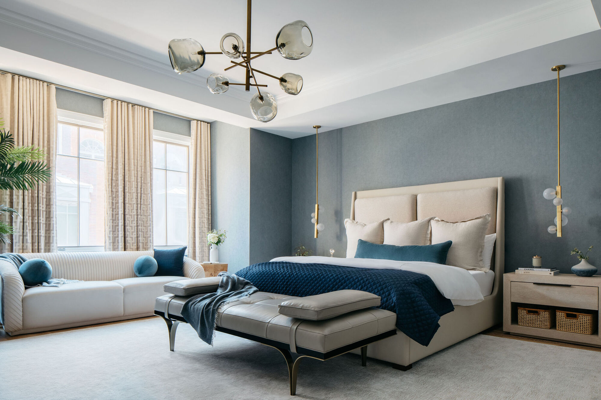 A bedroom with a blue and cream color palette