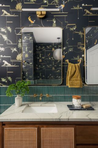 black wallpaper with leopard peacock plant gold pattern thin rectangular teal tiles along lower third of wall gray stone...