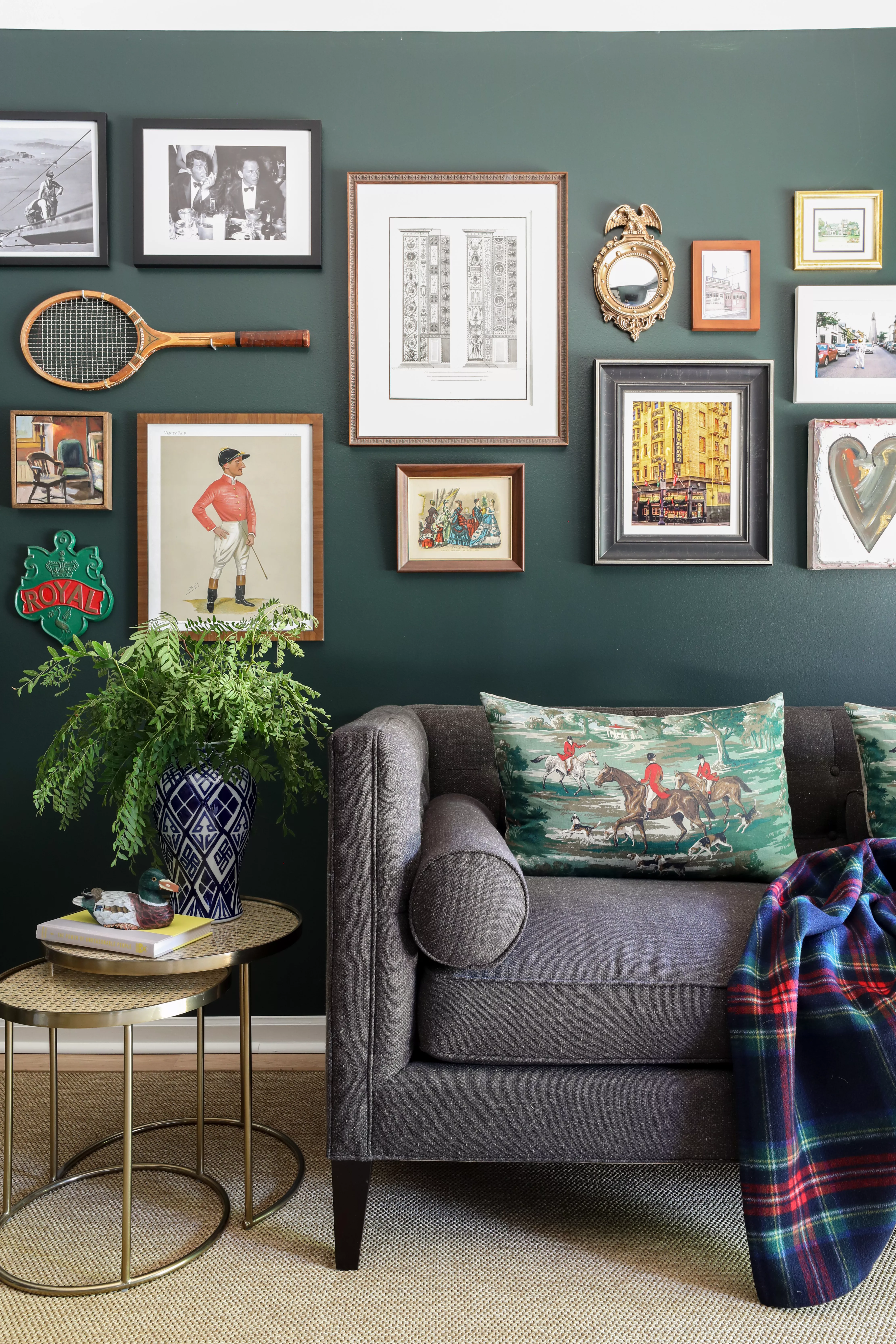 Living room with gray couch, green wall, and gallery wall art
