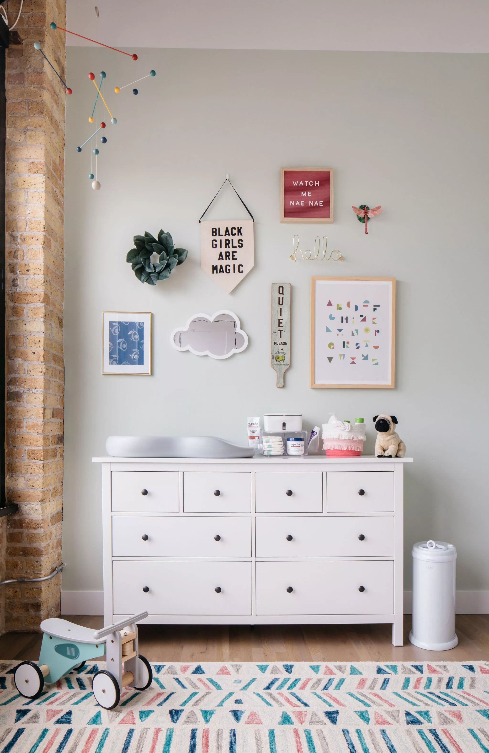 Nursery with gallery wall and printed rug