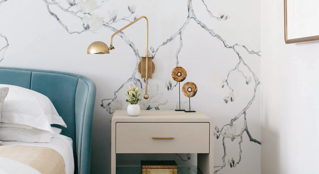 Phillip Jeffries wallpaper, RH sconces and Interlude Home bedside tables in the primary bedroom. PHOTOGRAPHED BY MARGARET RAJIC