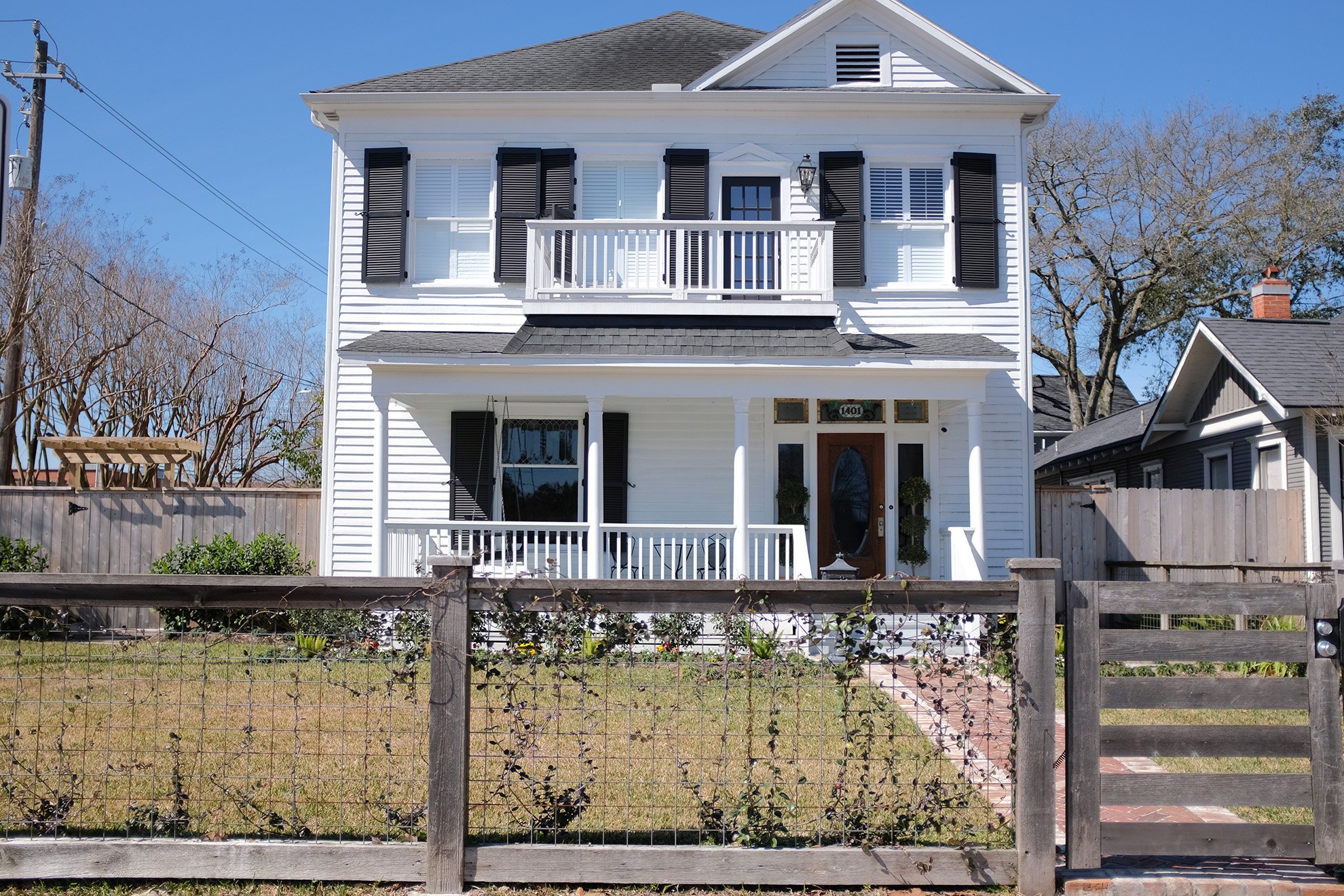 The front exterior of this home on 1401 Oxford is a gorgeous white with black shutters. This classic historical architechture has been meticulously preserved.