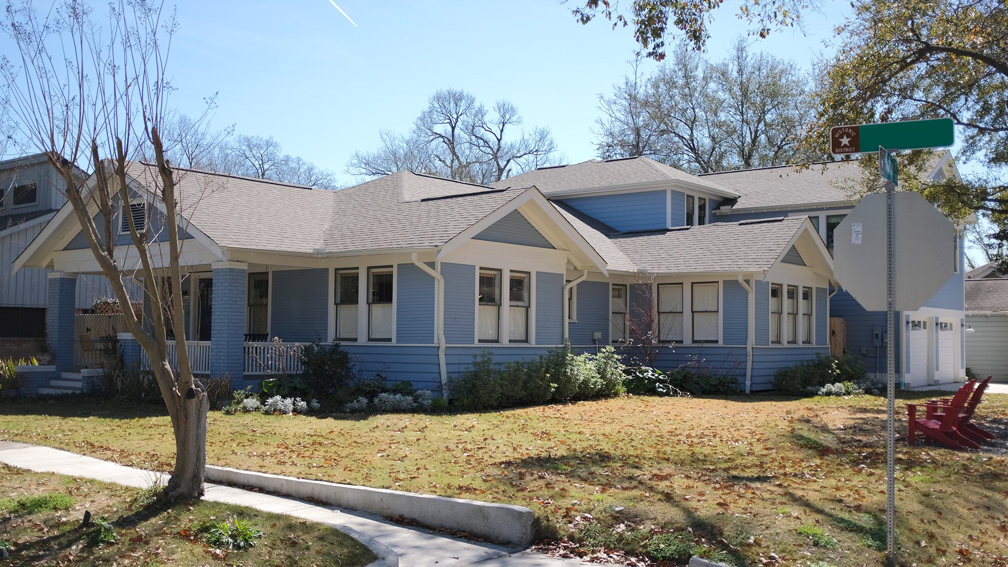 The front exterior of a blue home boasts excellent craftsmanship.