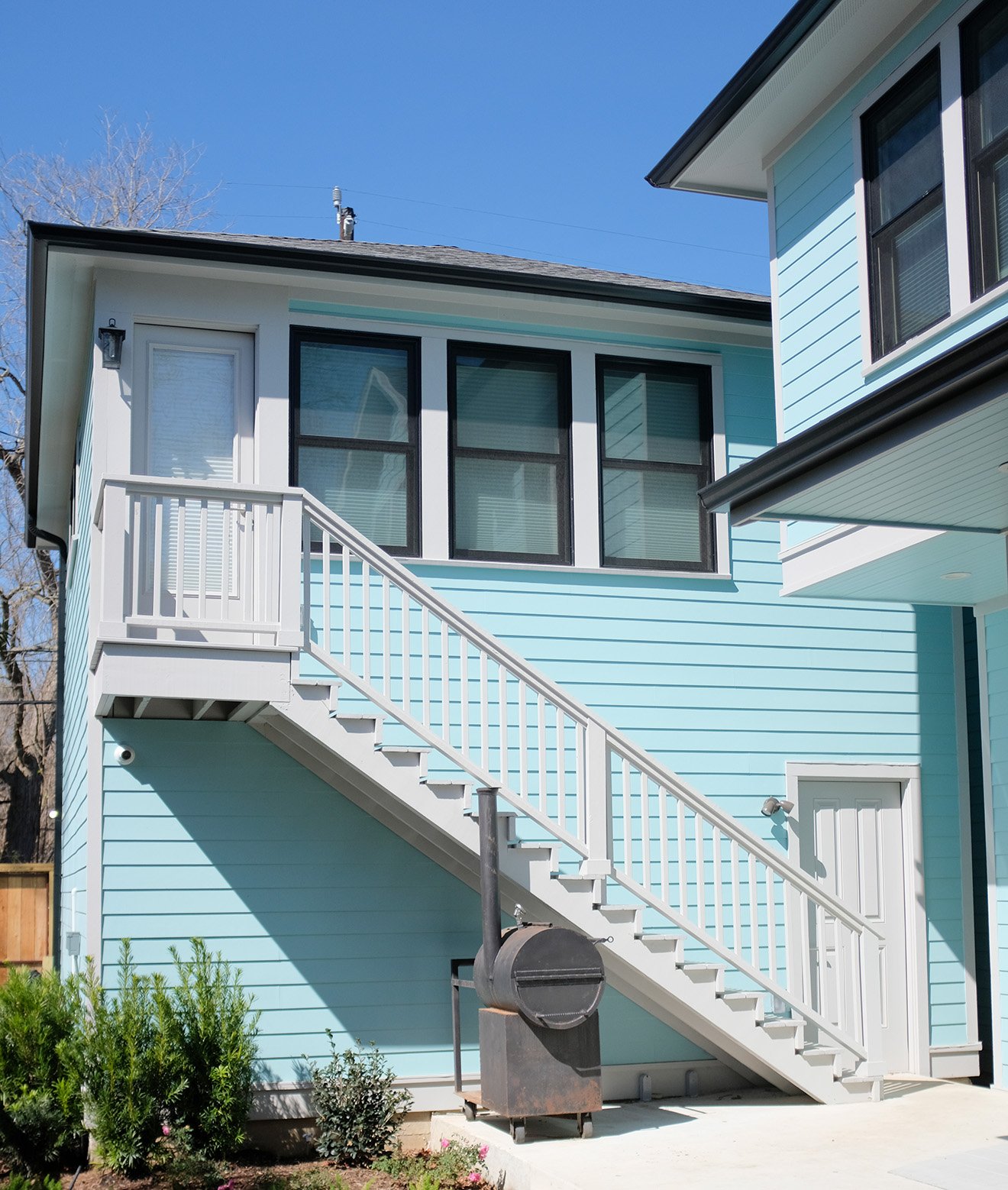 The front exterior of thegarage apartment for a light blue bungalow in the heights.