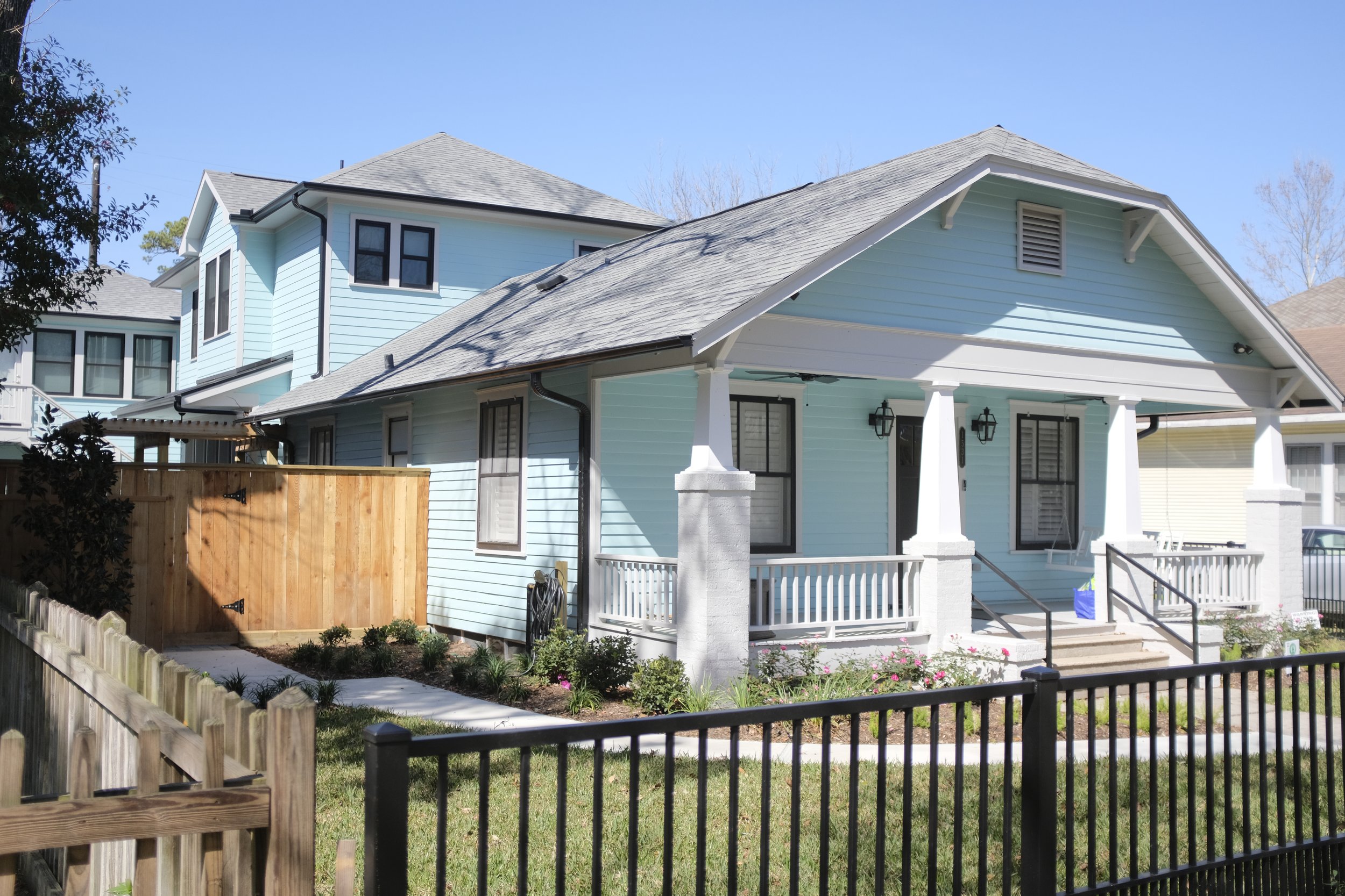 A light blue, historical bungalow house