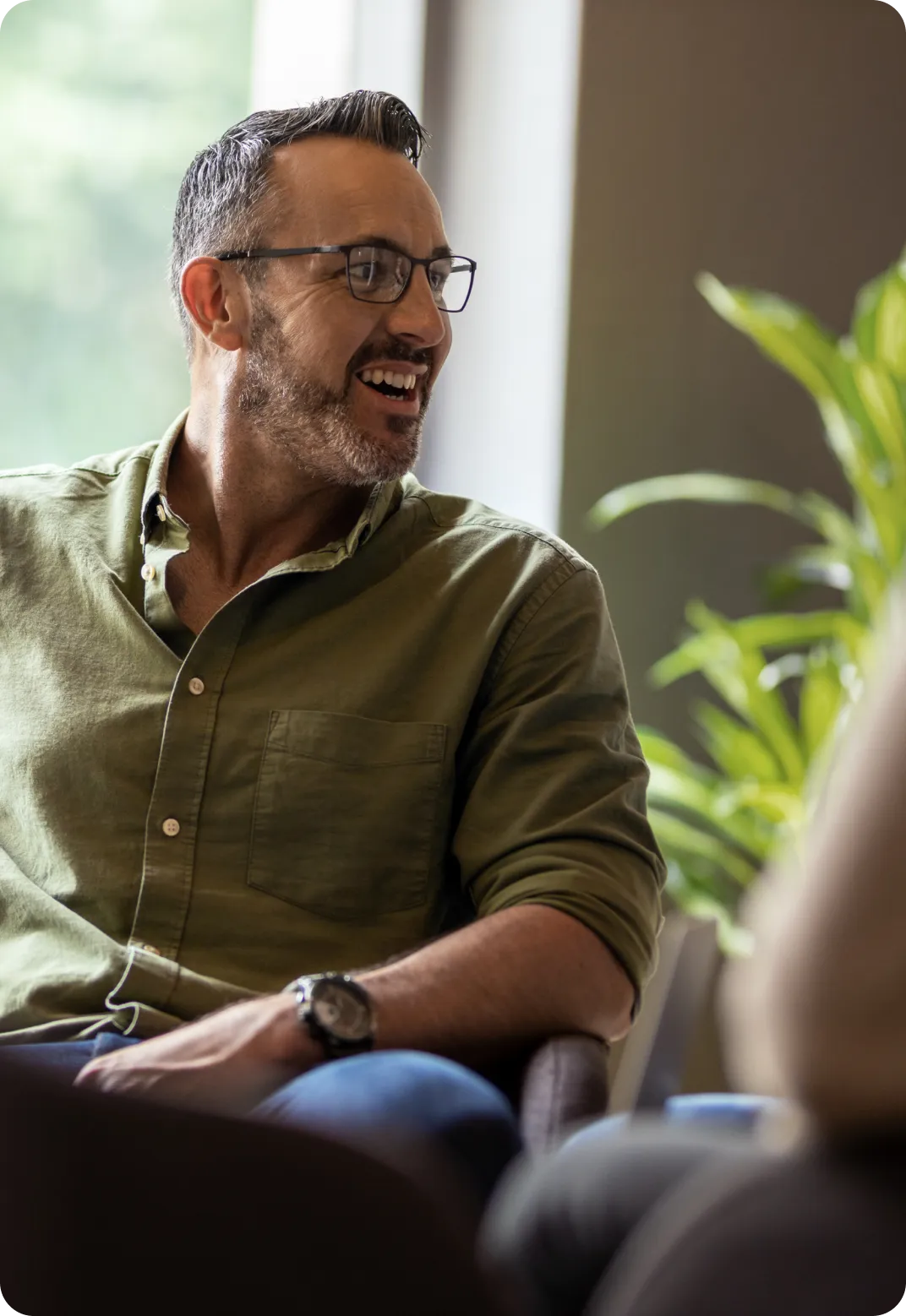 man in a green shirt with glasses
