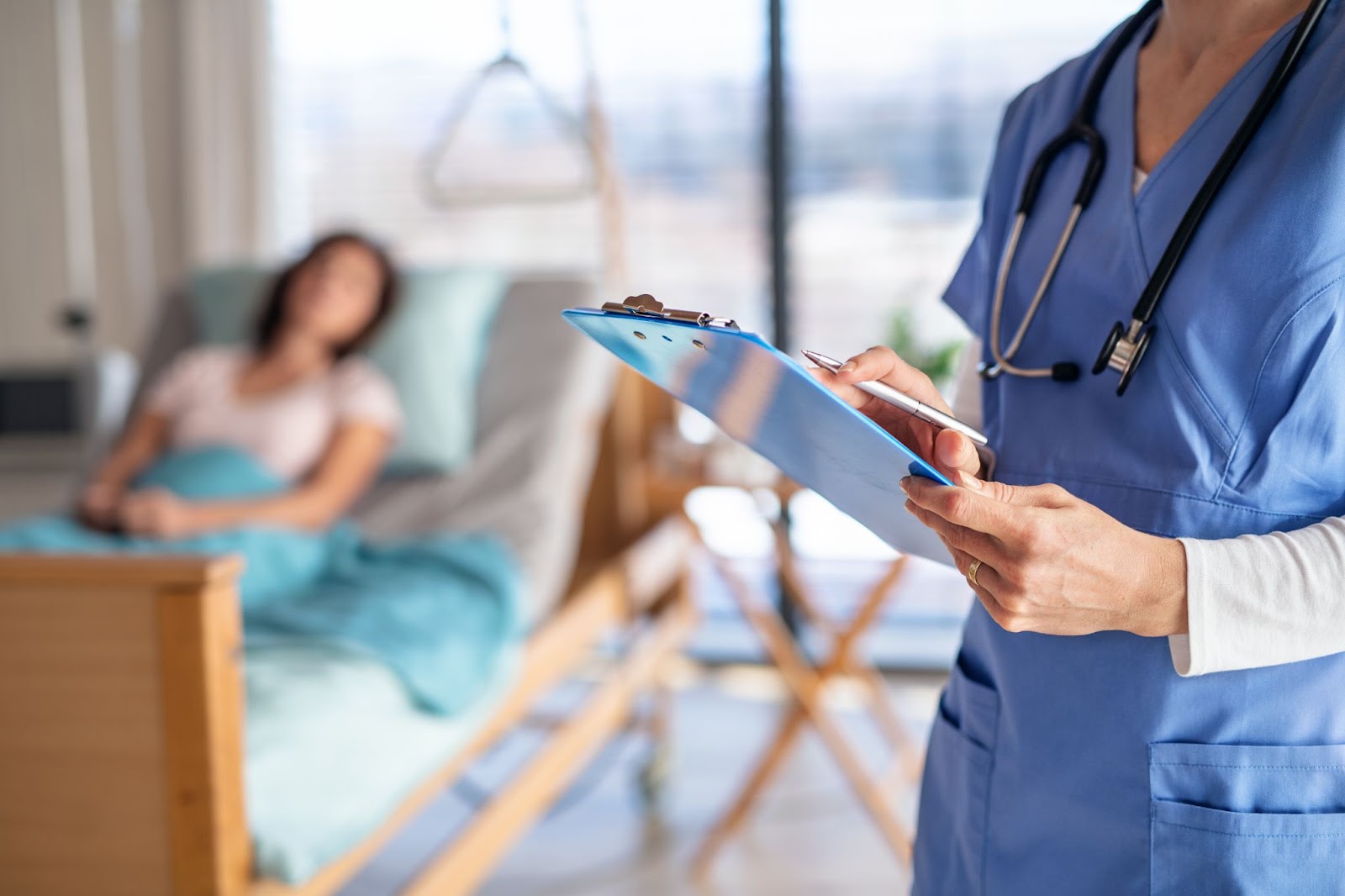 A healthcare professional records patient information during a patient consultation
