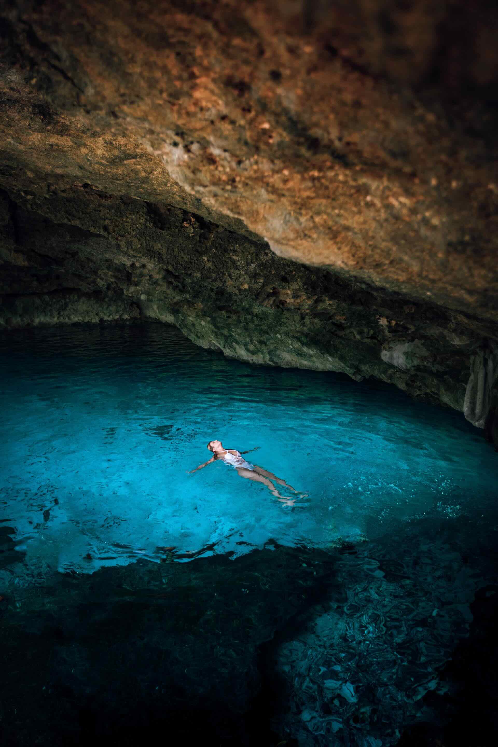 swimming in a cenote inside the cave