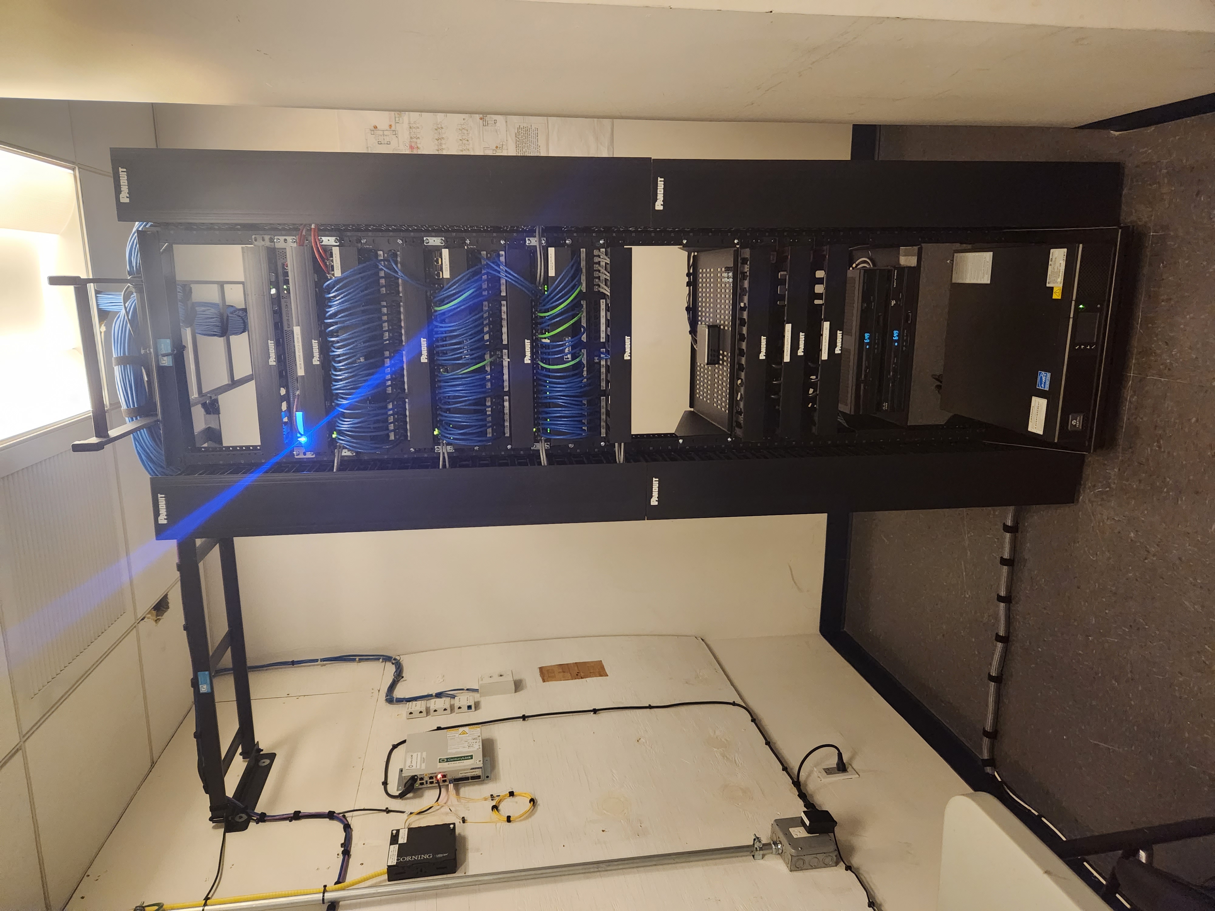 floor standing network rack with 100s of cables patched into switching equipment