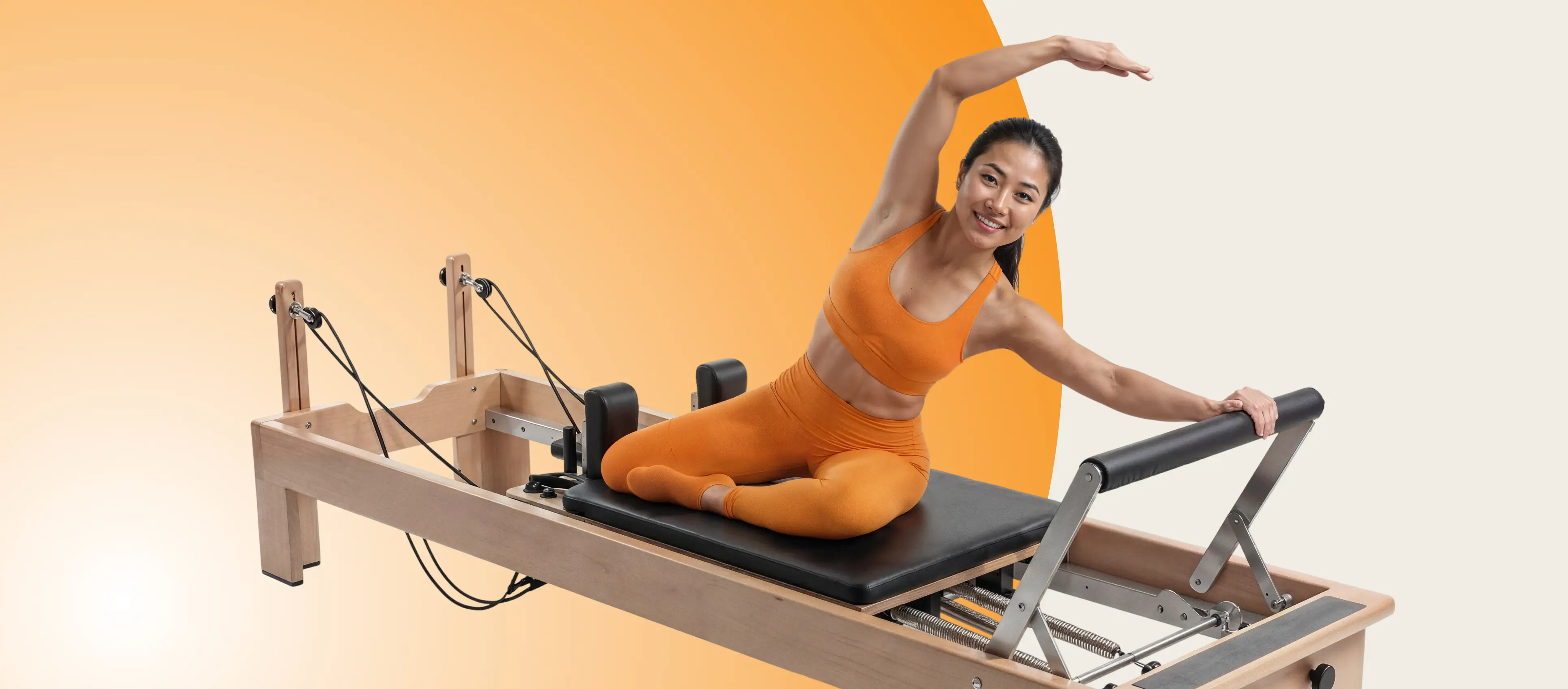 Woman practicing Pilates on a reformer in the studio