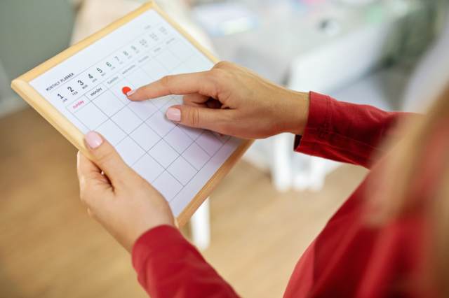 Mutter plant eine Wochenroutine mit Aufgaben
