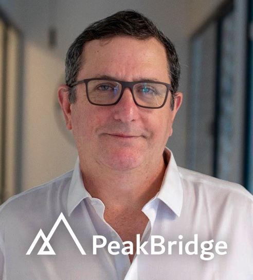 Mujer de cabello corto y oscuro sonriendo, vestida con blazer claro y pendientes de aro.