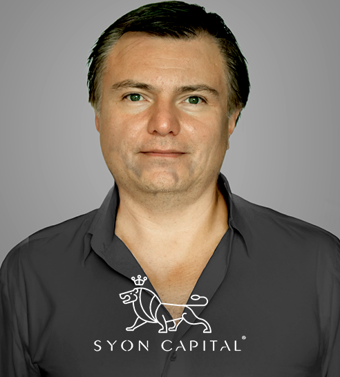 Mujer de cabello corto y oscuro sonriendo, vestida con blazer claro y pendientes de aro.