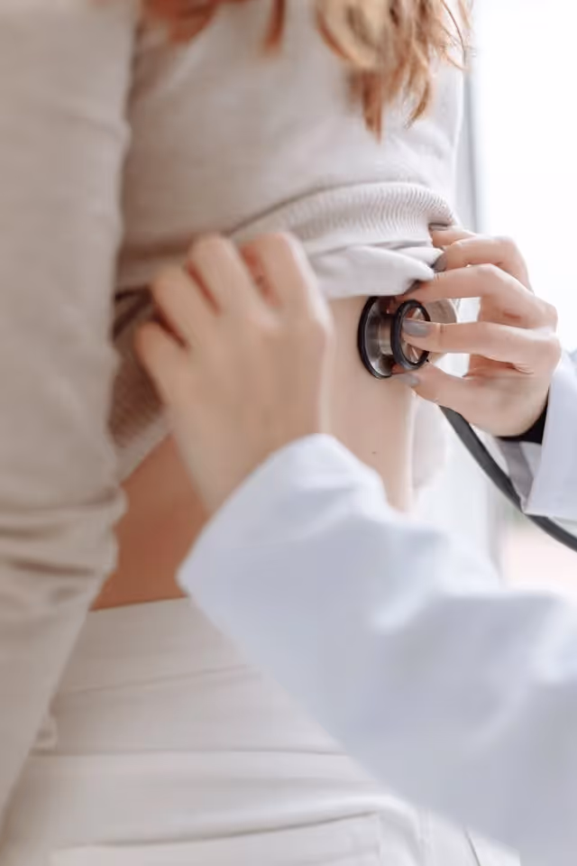 doctor using stethoscope on a patient