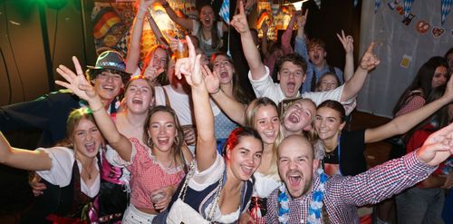 Lachende, gezellige mensen die oktoberfest aan het vieren zijn