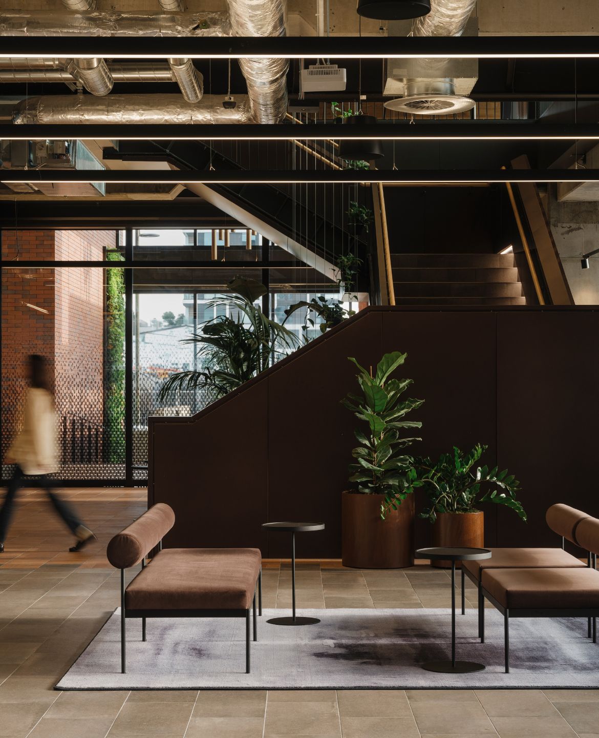Layered greenery throughout the Mott MacDonald workplace creates a more connected and people-focused environment within the contemporary office setting.